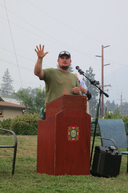 Mike Oxendine speaking while standing behind a podium